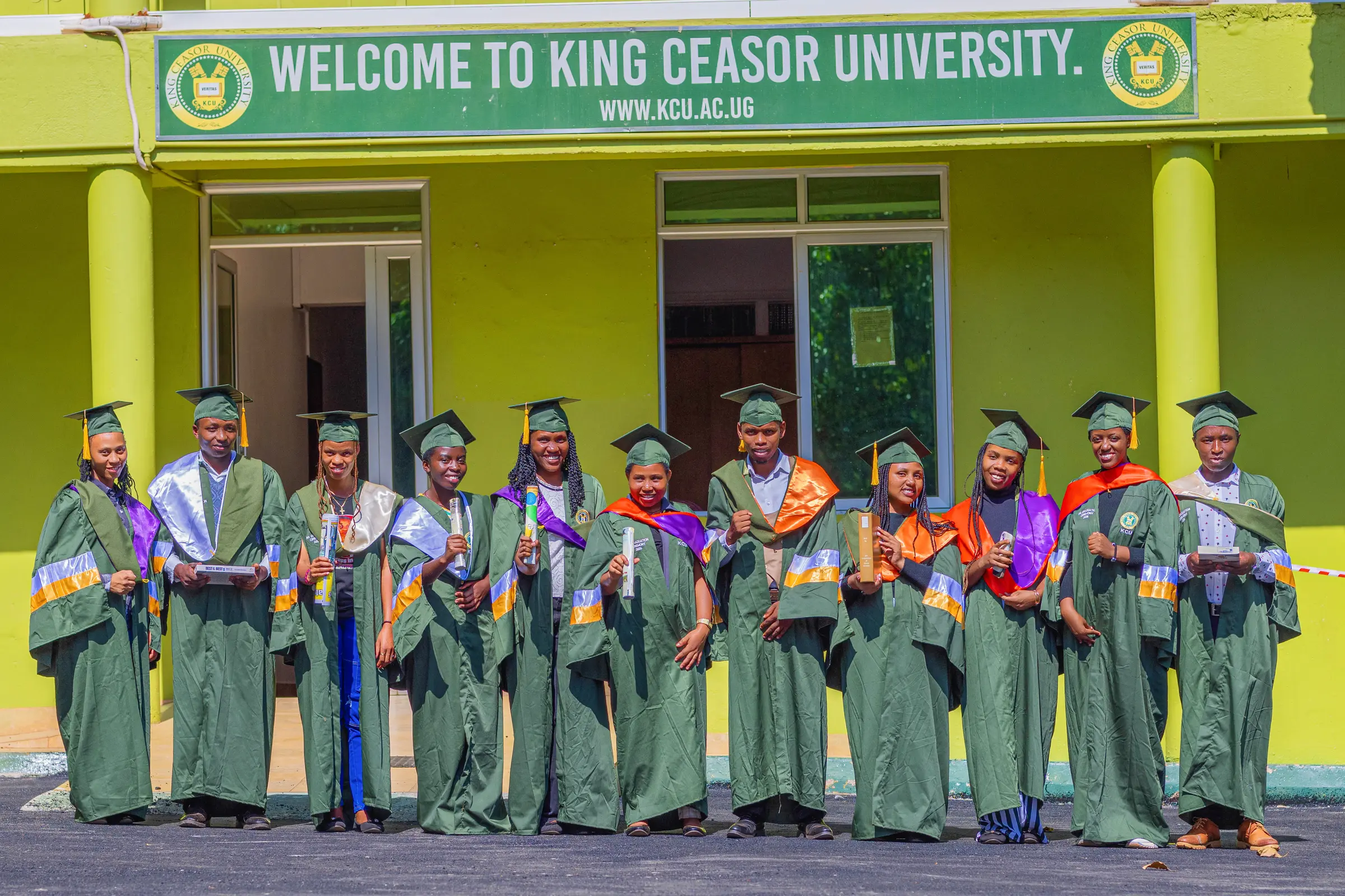 King Ceasor University graduates standing together outside a campus building