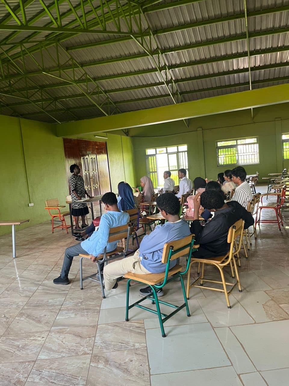 King Ceasor University Dean of Students team addressing new and continuing international students during a meeting on 4 September 2026